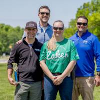 The top two teams pose for a group photo with trophies